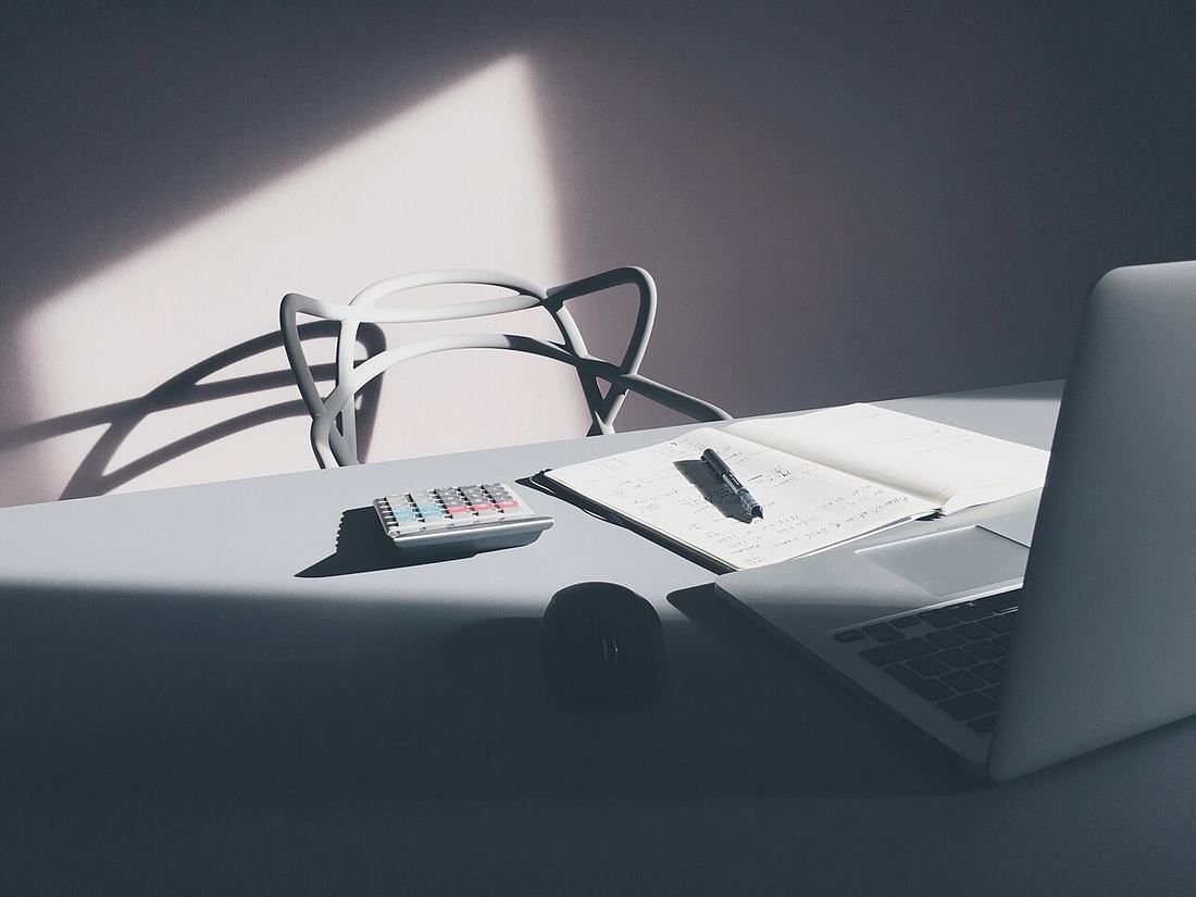 A laptop and a calculator on a desk