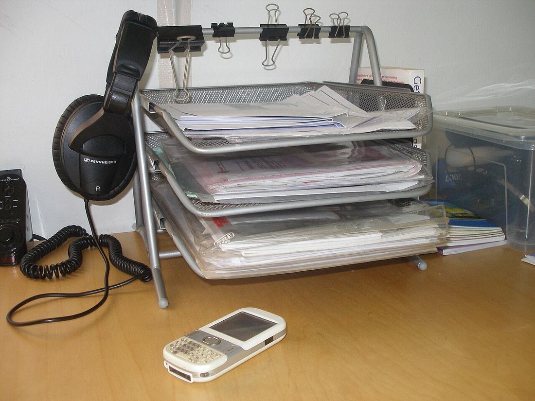 Paperwork sorted in inbox trays